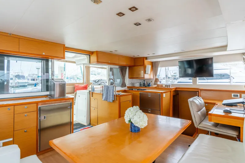 Slide: The Image of Interior of 2013 Lagoon 450 yacht with modern kitchen and dining area. - 103