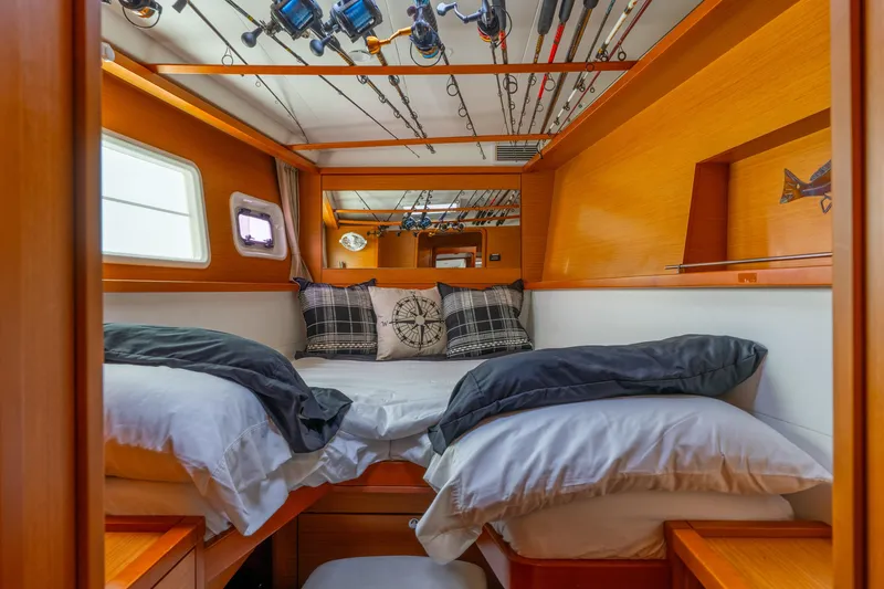 Slide: The Image of Cozy cabin interior of 2013 Lagoon 450 catamaran with fishing rods and nautical decor. - 106