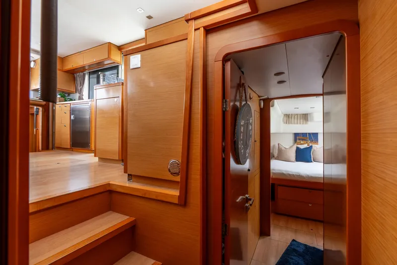 Slide: The Image of Interior of 2013 Lagoon 450 yacht, featuring a cozy bedroom and modern kitchen area. - 110