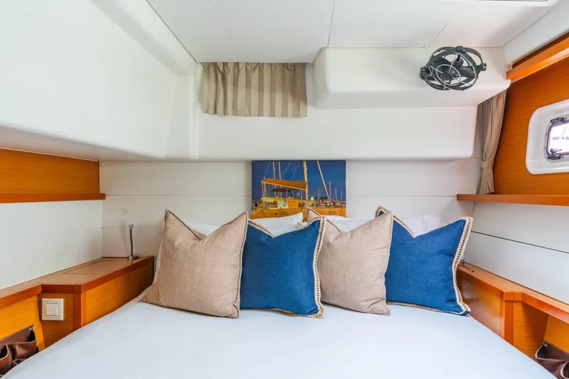 Slide: The Image of Cozy cabin interior of 2013 Lagoon 450 yacht with stylish pillows and nautical decor. - 111