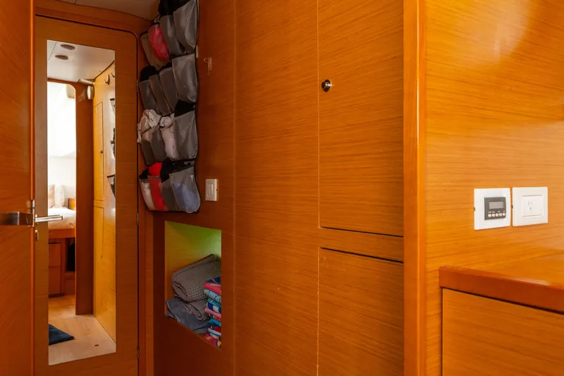 Slide: The Image of Interior of 2013 Lagoon 450 yacht with wooden cabinetry and organized storage. - 115