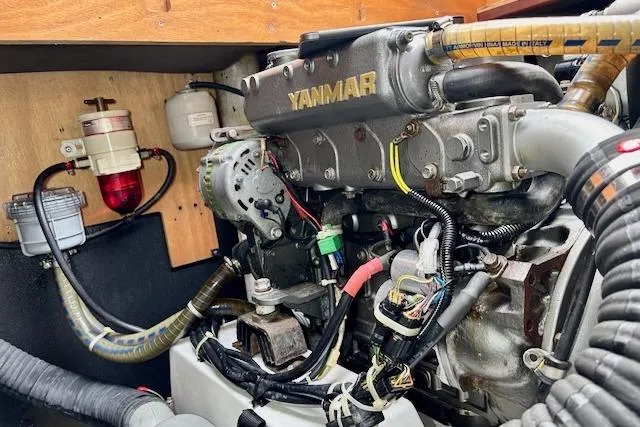 Slide: The Image of 2013 Lagoon 450 catamaran docked in a marina, reflecting on calm water. - 12