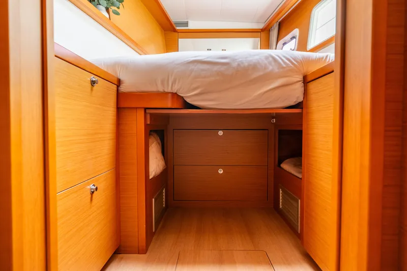 Slide: The Image of Interior cabin of 2013 Lagoon 450 catamaran with wooden finish and storage drawers. - 126