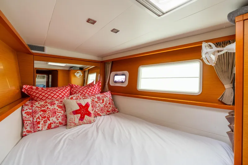 Slide: The Image of Cozy cabin interior of 2013 Lagoon 450 yacht with decorative pillows and window view. - 127