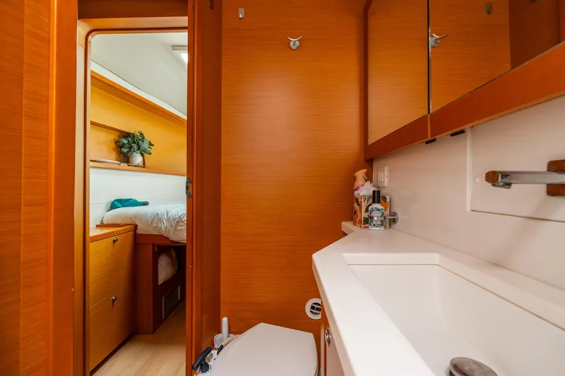 Slide: The Image of Interior of 2013 Lagoon 450 yacht showing bathroom and cozy bedroom. - 130