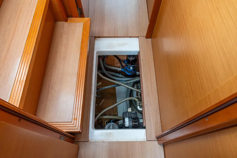 Slide: The Image of Interior view of 2013 Lagoon 450 yacht showing underfloor compartment with visible plumbing. - 138
