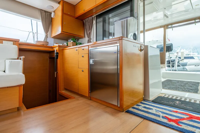 Slide: The Image of Interior of 2013 Lagoon 450 yacht with wooden cabinetry and stainless steel appliances. - 141
