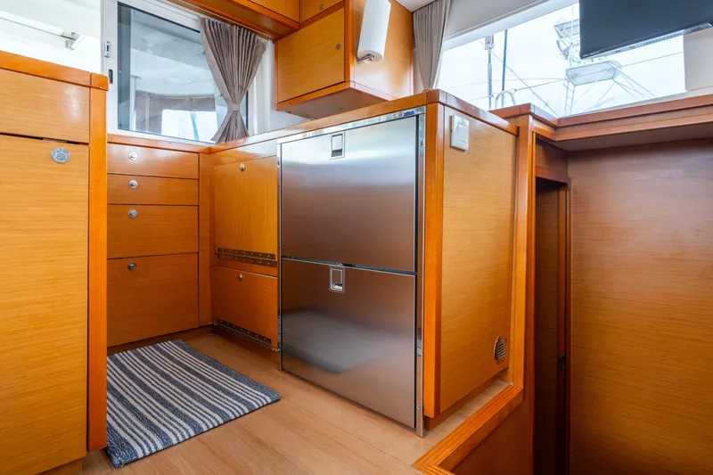 Slide: The Image of Interior of 2013 Lagoon 450 yacht with wooden cabinetry and stainless steel appliances. - 142