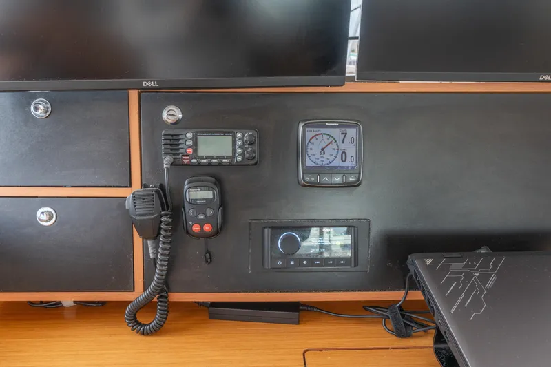 Slide: The Image of Control panel of a 2013 Lagoon 450 catamaran with navigation and communication equipment. - 144