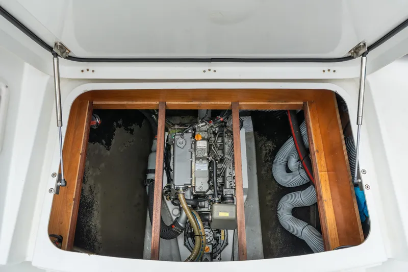 Slide: The Image of Engine compartment of a 2013 Lagoon 450 catamaran, showcasing mechanical components and hoses. - 147