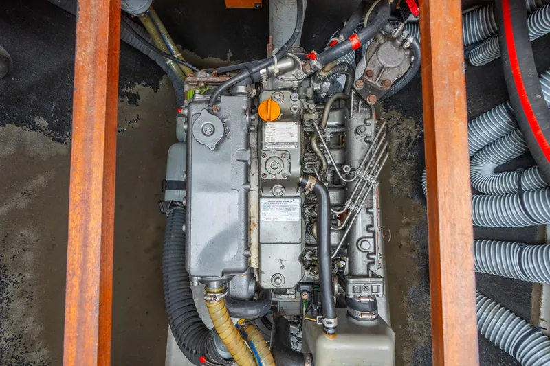 Slide: The Image of Engine compartment of a 2013 Lagoon 450 catamaran, showcasing detailed mechanical components. - 149