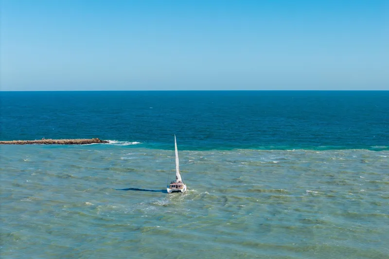 Slide: The Image of Sailboat Lagoon 450 (2013) navigating calm blue ocean waters. - 155