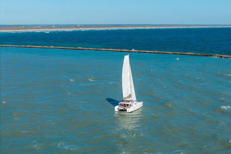 Slide: The Image of Sailing catamaran Lagoon 450, 2013 model, navigating blue ocean waters. - 156