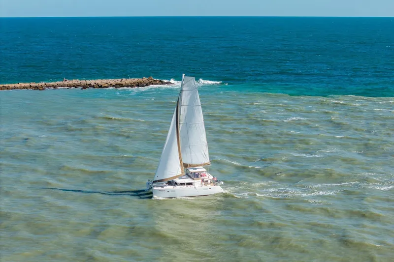 Slide: The Image of Sailing catamaran Lagoon 450, 2013 model, navigating clear blue ocean waters. - 157