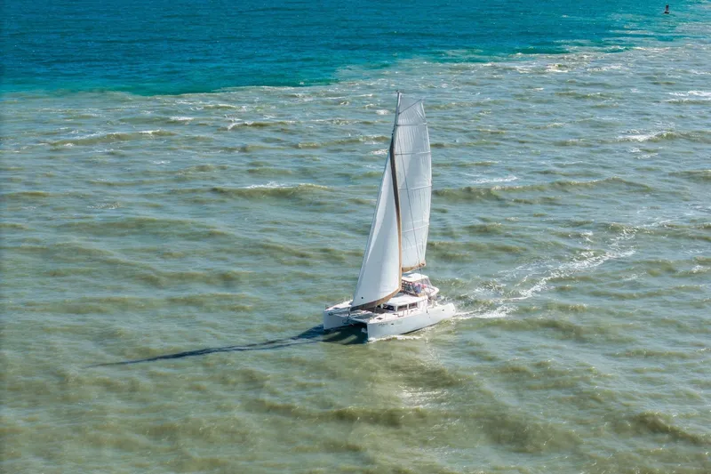 Slide: The Image of Sailing catamaran Lagoon 450, 2013 model, cruising on turquoise ocean waters. - 158