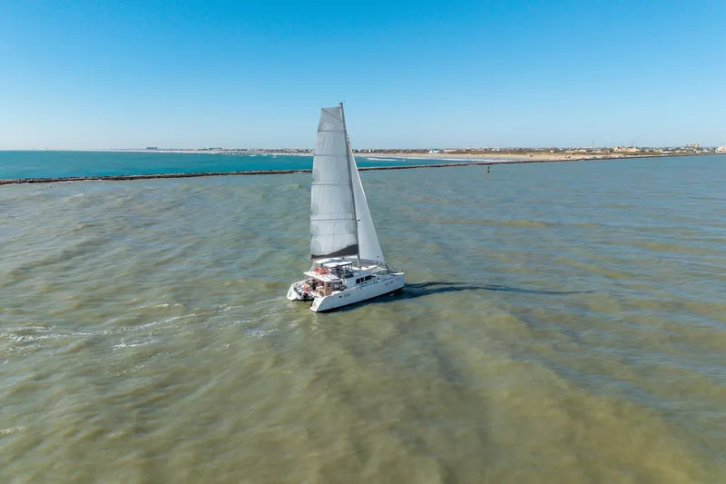 Slide: The Image of Sailing Lagoon 450 catamaran, 2013 model, on open water under clear blue sky. - 159