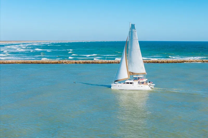 Slide: The Image of Sailing Lagoon 450 catamaran on open sea, 2013 model, under clear blue sky. - 160