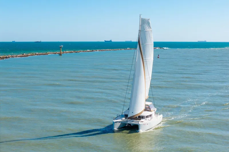 Slide: The Image of Sailing catamaran Lagoon 450, 2013 model, navigating calm ocean waters. - 161