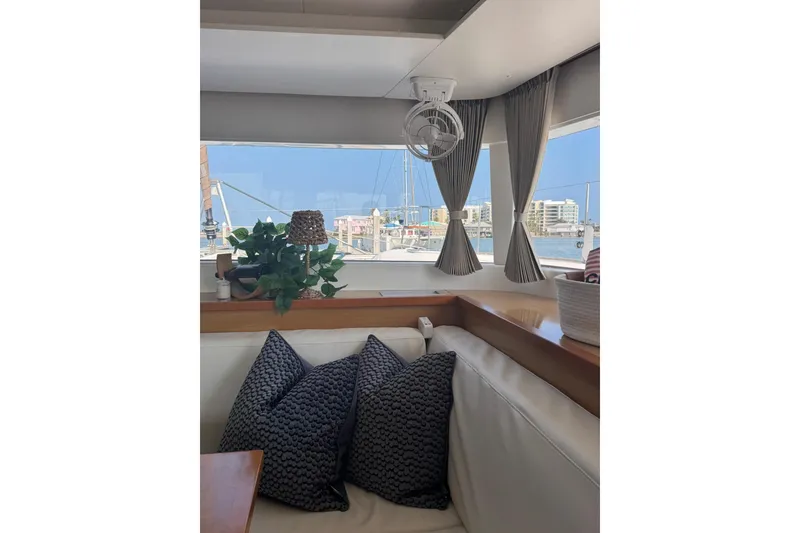 Slide: The Image of Interior view of 2013 Lagoon 450 catamaran cockpit with steering wheel and navigation equipment. - 23