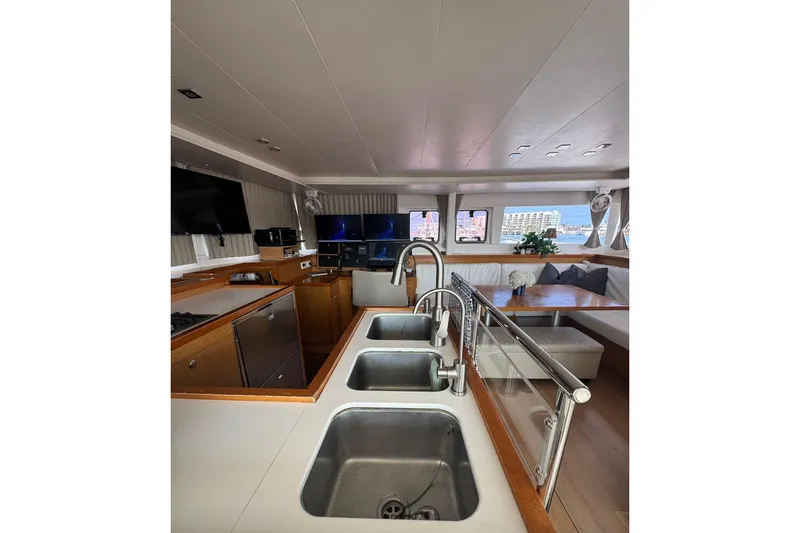 Slide: The Image of Lagoon 450 sailboat cockpit with winch and ropes, 2013 model, ocean view. - 27