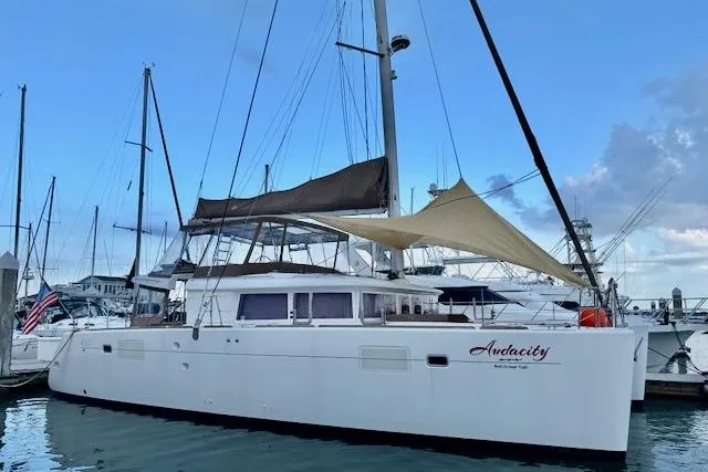 Slide: The Image of 2013 Lagoon 450 catamaran sailing on open water, viewed from above. - 3