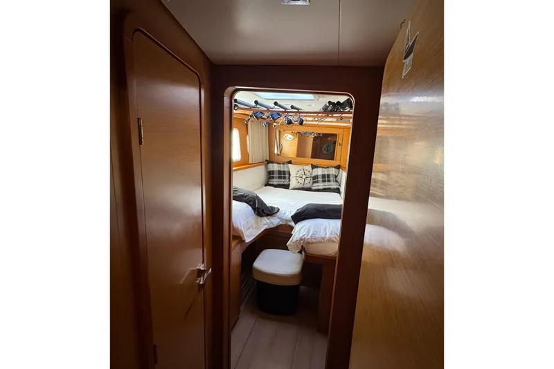 Slide: The Image of Lagoon 450 catamaran deck view with red-striped seating, sailing on open sea, 2013 model. - 31