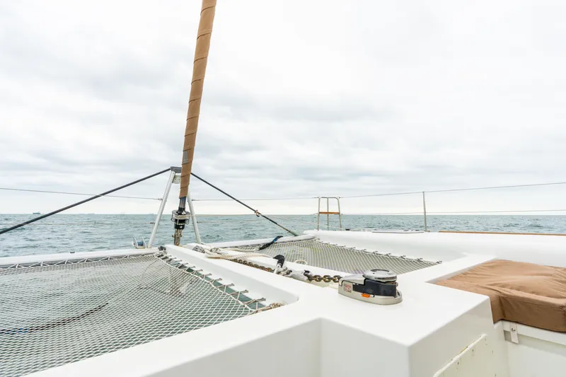 Slide: The Image of Lagoon 450 catamaran deck view, 2013 model, sailing on open sea under cloudy sky. - 39