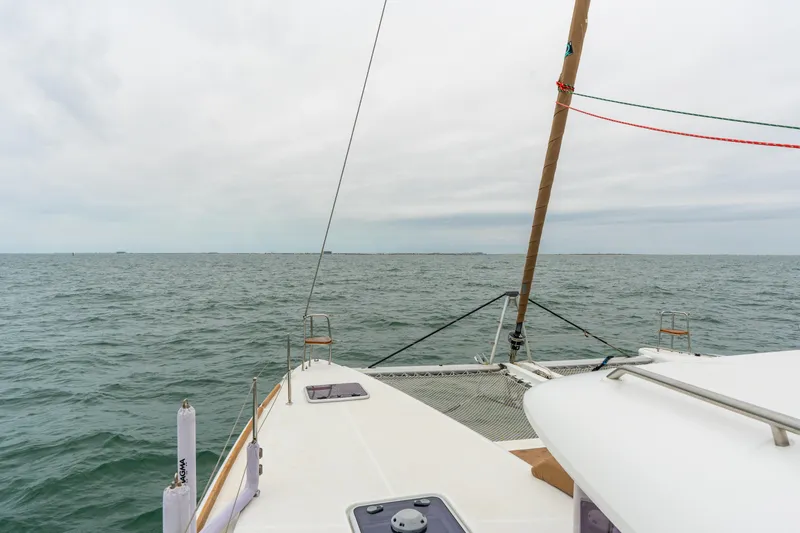 Slide: The Image of Lagoon 450 catamaran sailing on open sea under cloudy skies, 2013 model. - 43