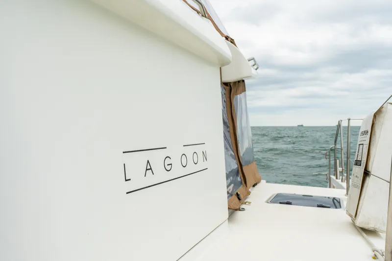Slide: The Image of Lagoon 450 catamaran from 2013 on open sea, showcasing sleek design and branding. - 44