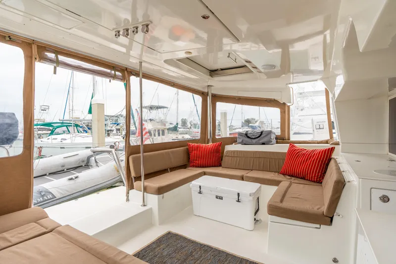 Slide: The Image of Spacious interior of 2013 Lagoon 450 catamaran with comfortable seating and red cushions. - 52