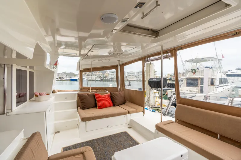 Slide: The Image of Interior of 2013 Lagoon 450 yacht with comfortable seating and marina view. - 55