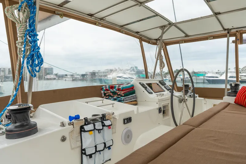 Slide: The Image of Interior view of 2013 Lagoon 450 catamaran helm with marina backdrop. - 59