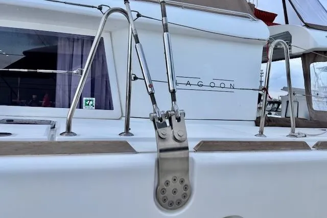 Slide: The Image of 2013 Lagoon 450 catamaran sailing on a sunny day near rocky shoreline. - 6