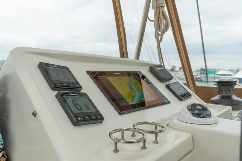 Slide: The Image of Control panel of 2013 Lagoon 450 catamaran with navigation instruments and compass. - 61
