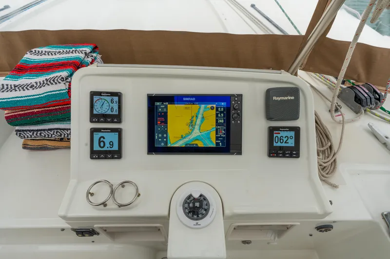 Slide: The Image of Control panel of a 2013 Lagoon 450 catamaran with navigation instruments and colorful towels. - 62