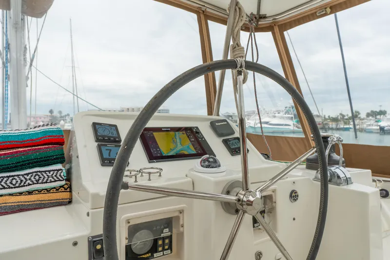 Slide: The Image of Helm of 2013 Lagoon 450 catamaran with navigation equipment and colorful blanket. - 64