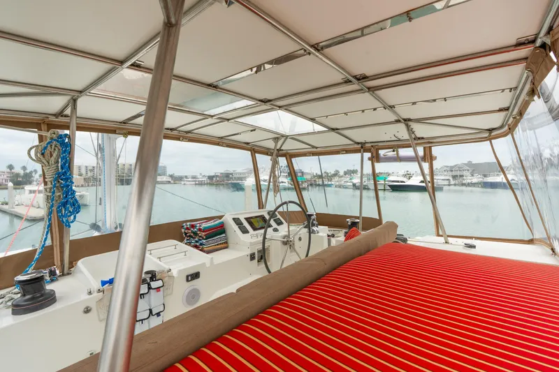 Slide: The Image of Interior view of 2013 Lagoon 450 catamaran with marina backdrop. - 68