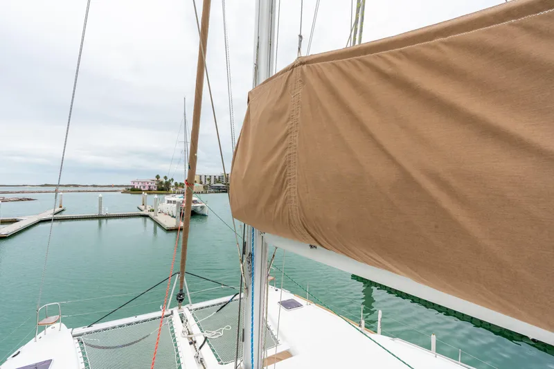 Slide: The Image of 2013 Lagoon 450 catamaran docked in a serene marina setting. - 69