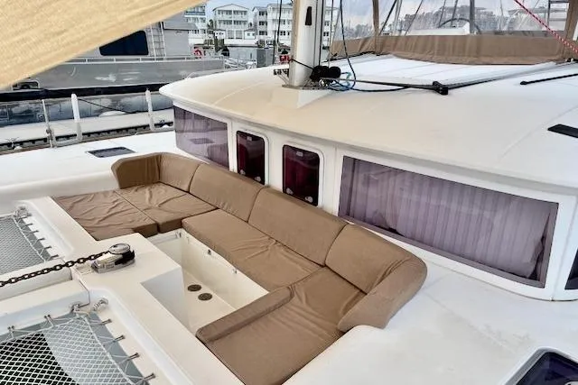 Slide: The Image of 2013 Lagoon 450 catamaran docked in marina, featuring sleek design and spacious deck. - 8