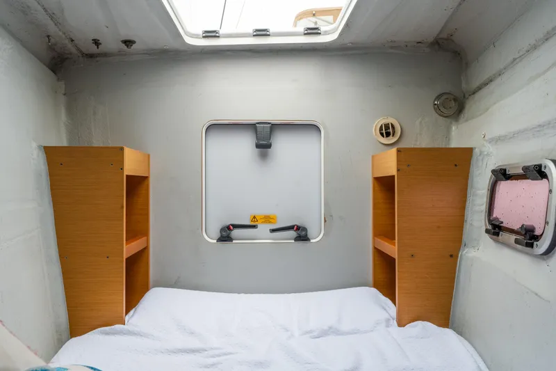 Slide: The Image of Cozy cabin interior of 2013 Lagoon 450 catamaran with wooden shelves and bedding. - 88