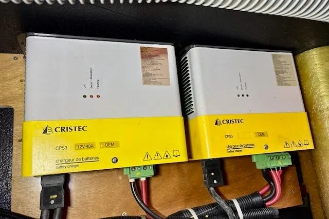 Slide: The Image of 2013 Lagoon 450 catamaran docked at marina with dinghy and overcast sky. - 9