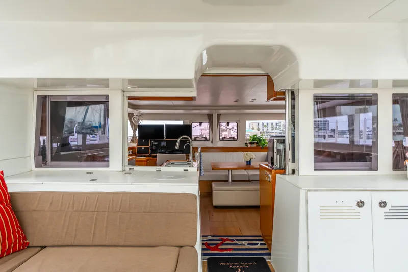 Slide: The Image of Interior view of 2013 Lagoon 450 catamaran, featuring modern seating and navigation area. - 91