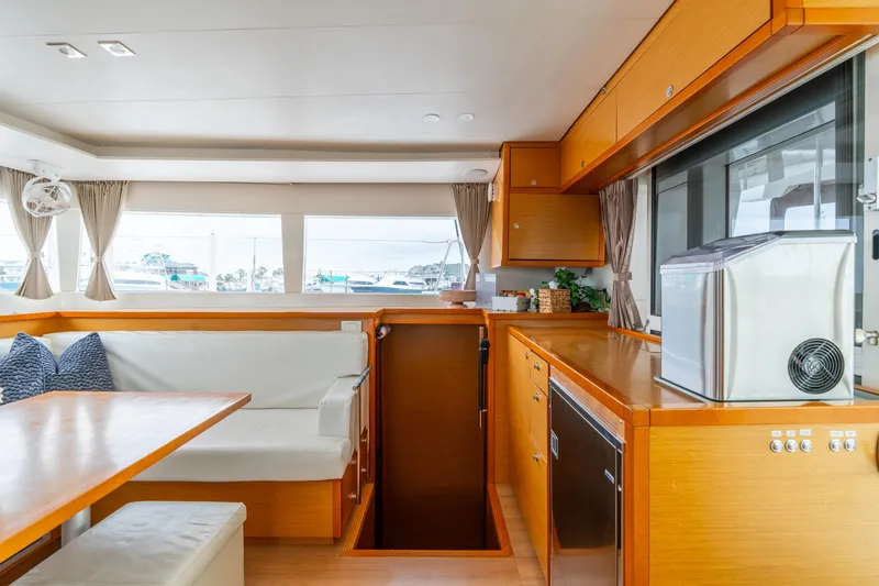 Slide: The Image of Interior of 2013 Lagoon 450 yacht with modern kitchen and dining area. - 96