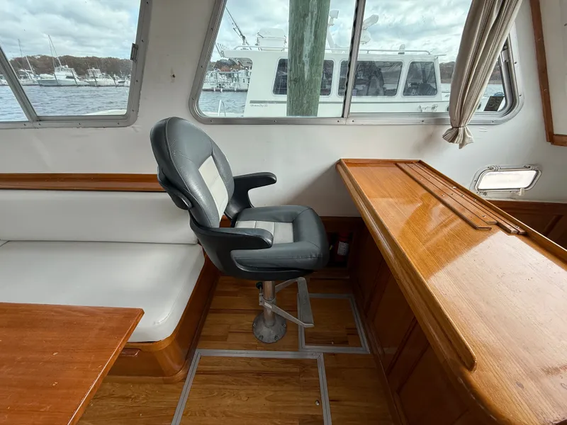 Slide: The Image of Interior of 1998 Wilbur 38 Downeast boat with seating and wooden surfaces. - 11