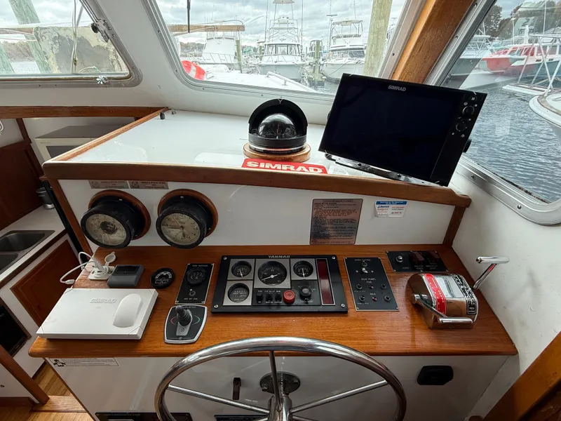 Slide: The Image of Helm of 1998 Wilbur 38 Downeast boat with navigation instruments and steering wheel. - 12