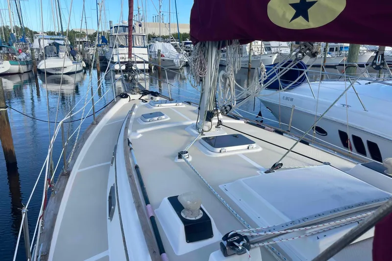 Slide: The Image of 1989 Island Packet 35 sailboat docked in marina, showcasing deck and rigging. - 12