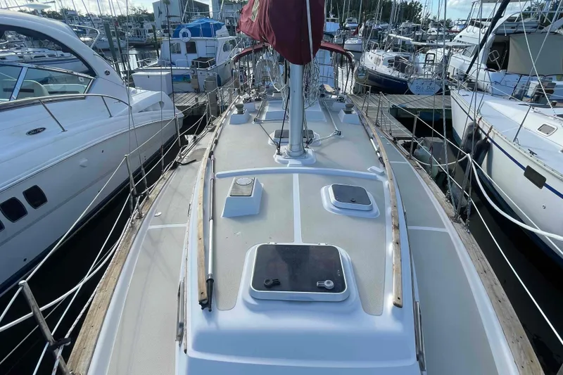 Slide: The Image of 1989 Island Packet 35 sailboat docked at marina, view of deck and mast. - 13
