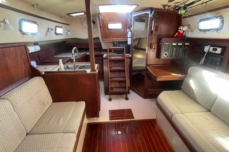 Slide: The Image of Interior of 1989 Island Packet 35 sailboat with wood finish and seating area. - 16