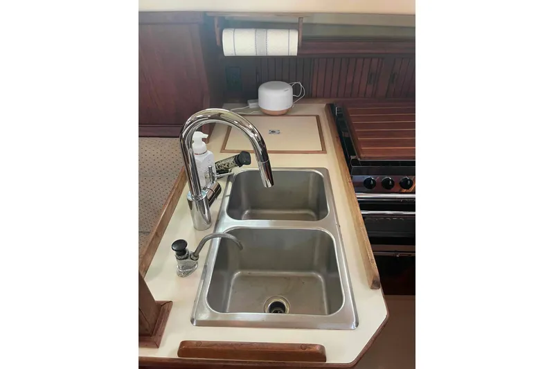Slide: The Image of 1989 Island Packet 35 yacht kitchen with dual sinks and stove. - 18