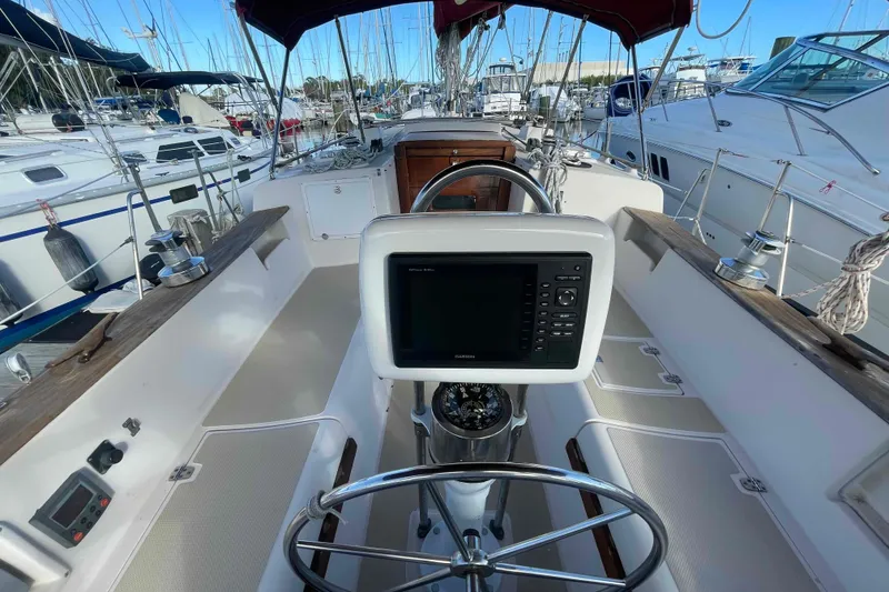 Slide: The Image of Cockpit of 1989 Island Packet 35 sailboat with navigation equipment and steering wheel. - 2